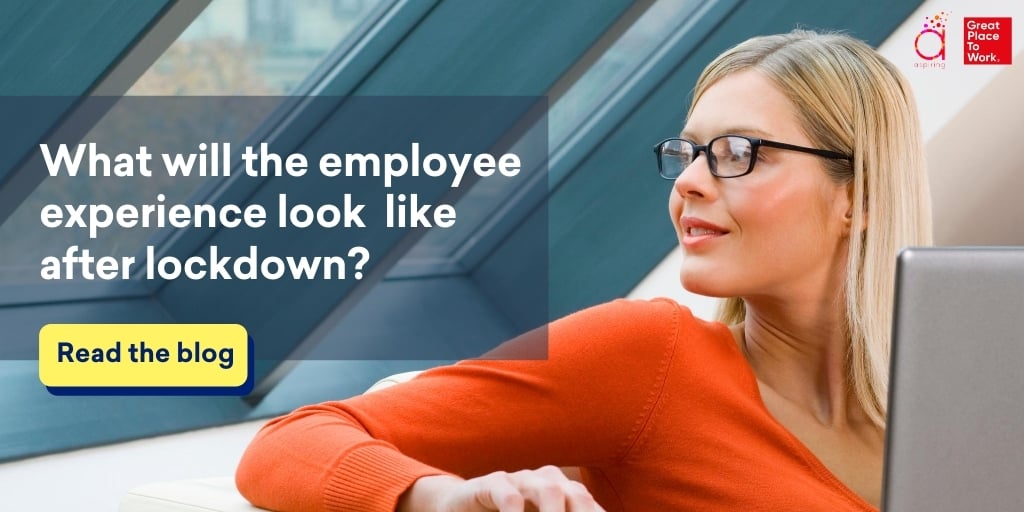 blond-woman-with-glasses-in-orange-sweater-looking-out-window