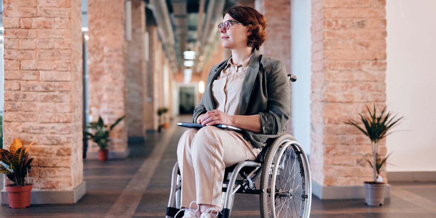 Woman in wheelchair in office space