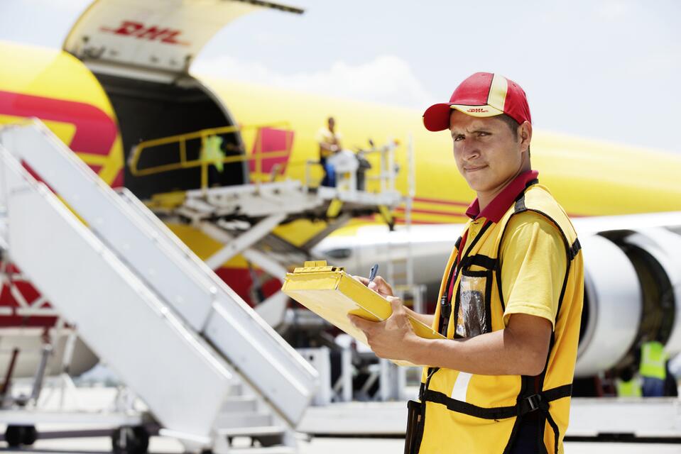 DHL-express-delivery-man-in-uniform-with-plane-cargo
