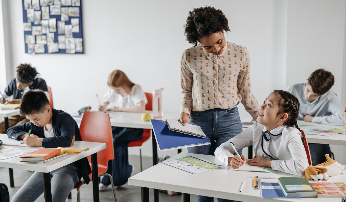 Teacher talking to student in classroom