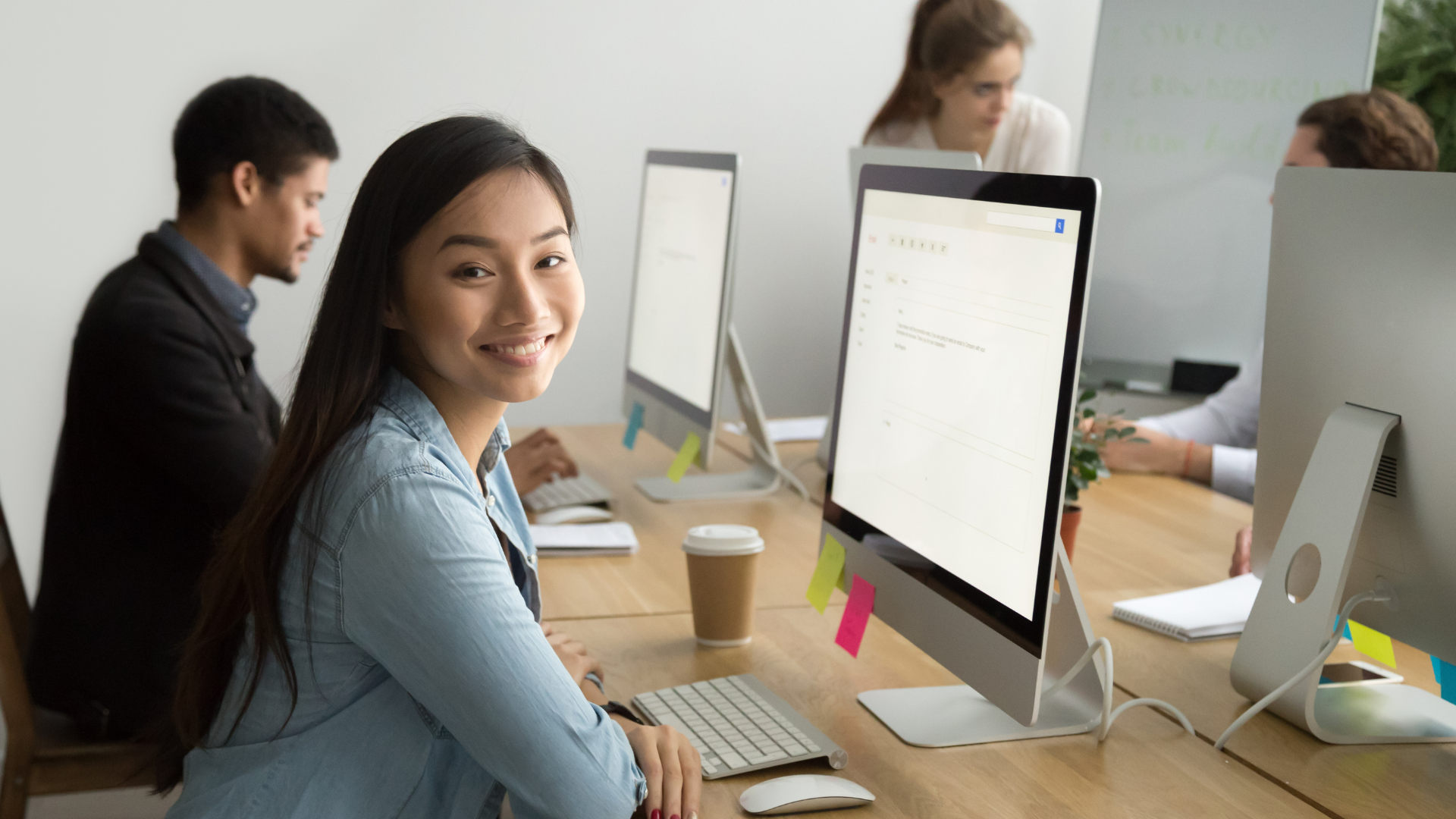woman-at-desktop-smiling-worlds-best-workplaces-2020