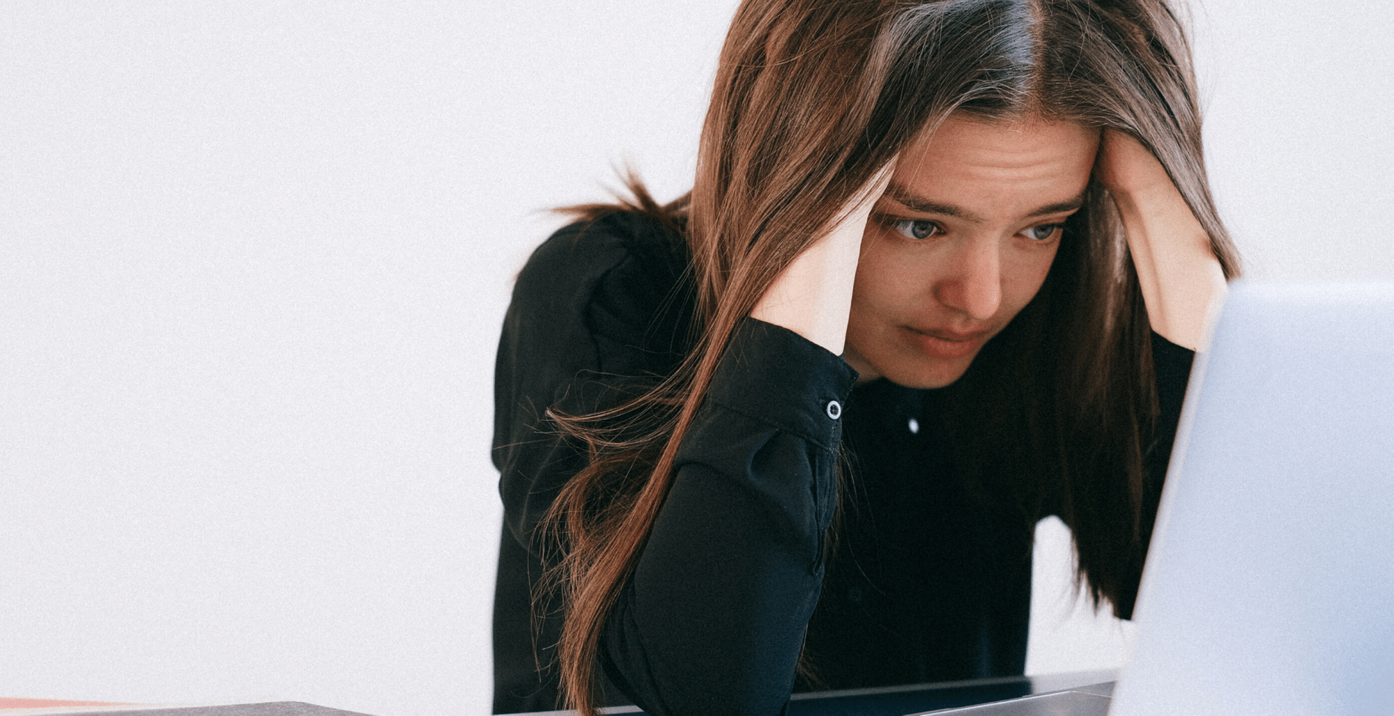 girl-in-black-sweater-with-hands-in-head-looking-stressed