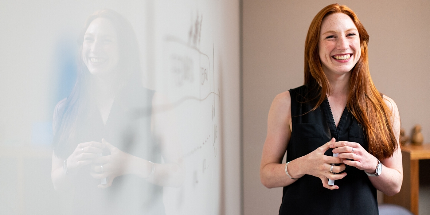 happy-redhead-woman-whiteboard-resilience