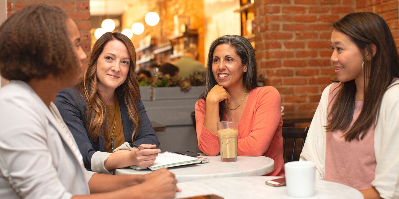 multiracial-coworkers-meeting-equity-at-work-uk-best-workplaces-for-women