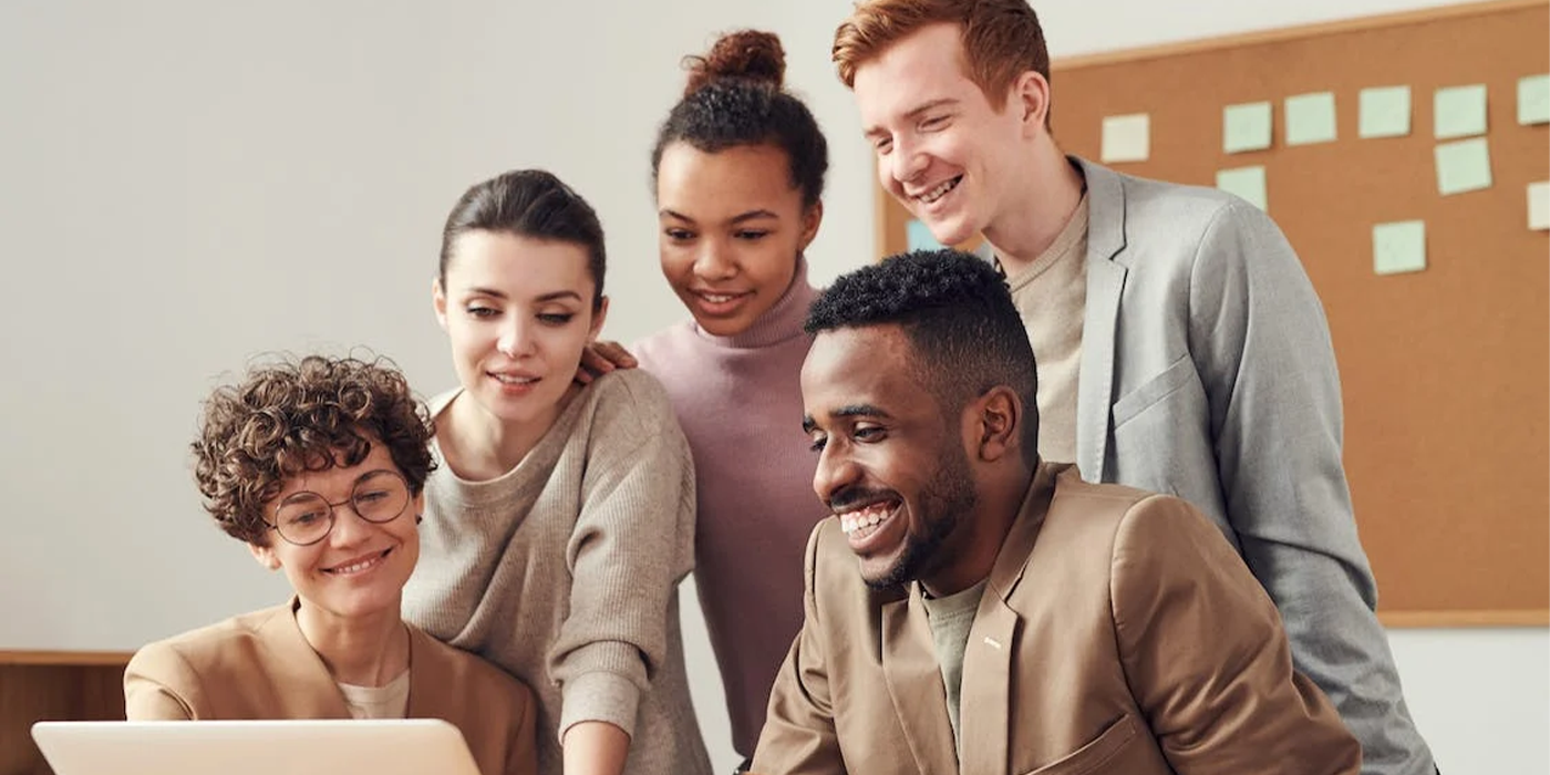 colleagues smiling with laptop