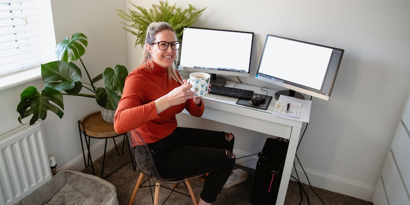 woman-smile-sitting-at- desktop-two-monitors-2021-competitive-advantage