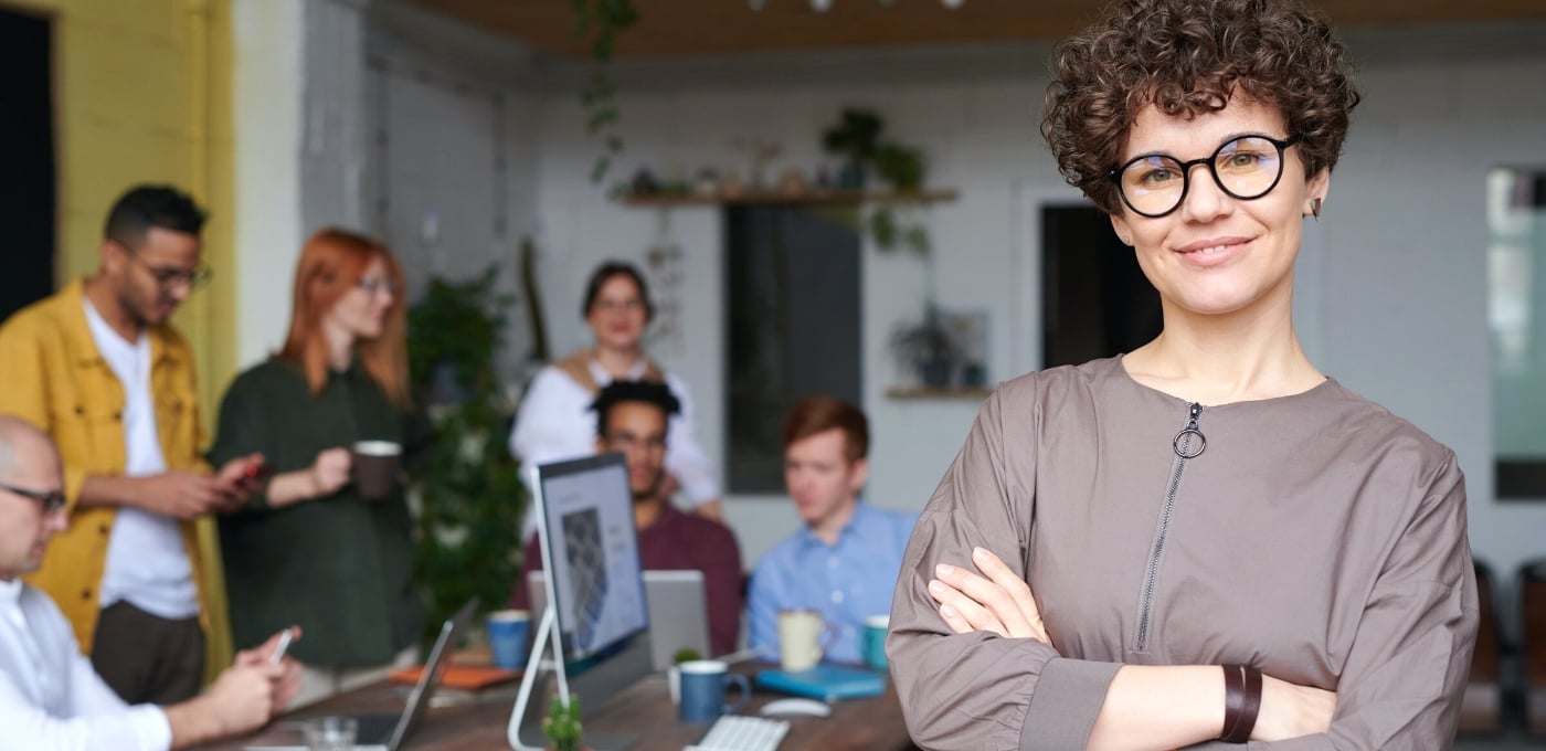 woman-wearing-glasses-in-tech-company-office-with-colleagues